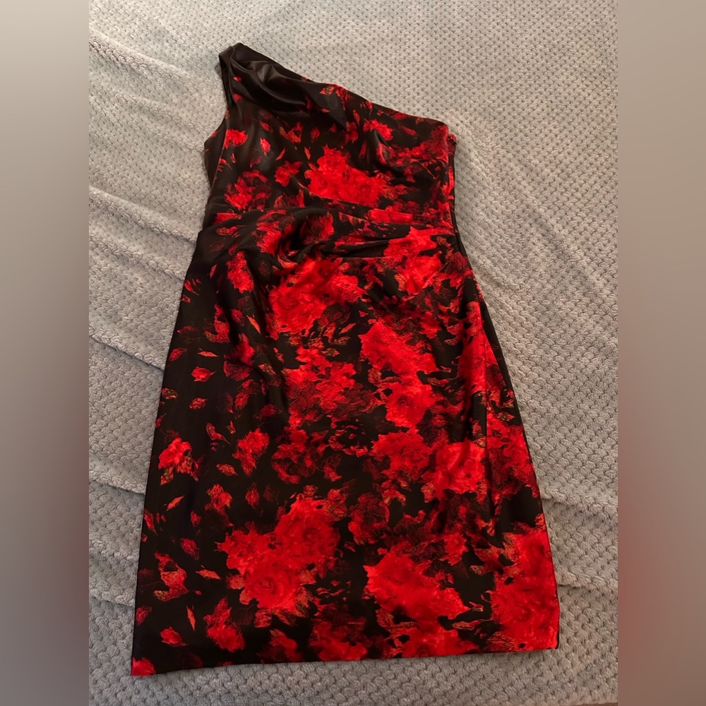 Polyester red and black one shoulder dress. Very cute. Used once size 10